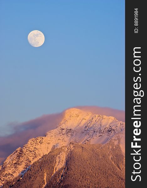 A full moon rises over Mt. Cheam near Chilliwack, BC Canada. A full moon rises over Mt. Cheam near Chilliwack, BC Canada