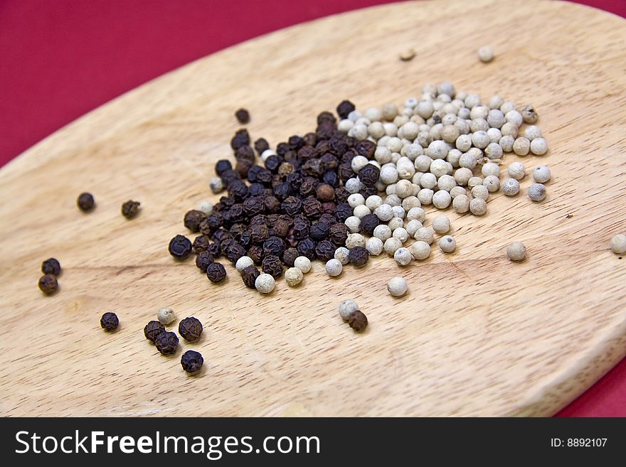 Mixed Pepper Grains On The Cutting Board With Mort