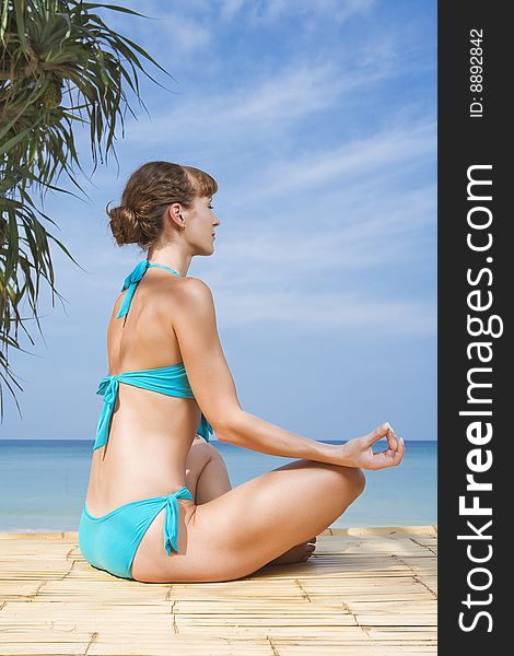 Portrait of young woman practicing yoga in summer environment