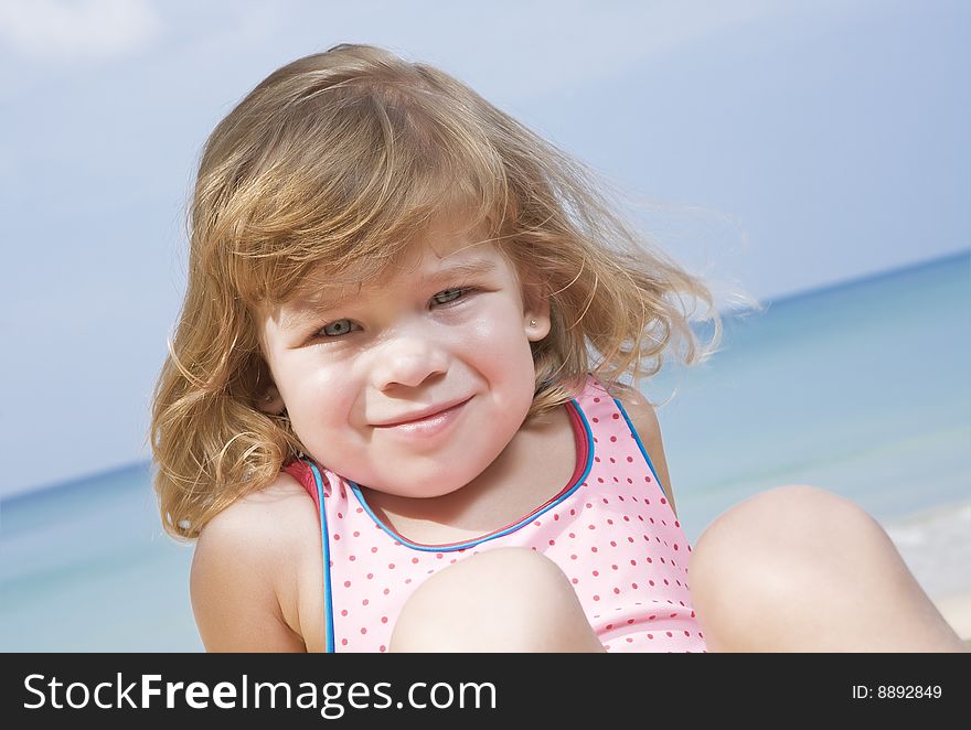 Portrait of nice little girl having fun on the beach. Portrait of nice little girl having fun on the beach