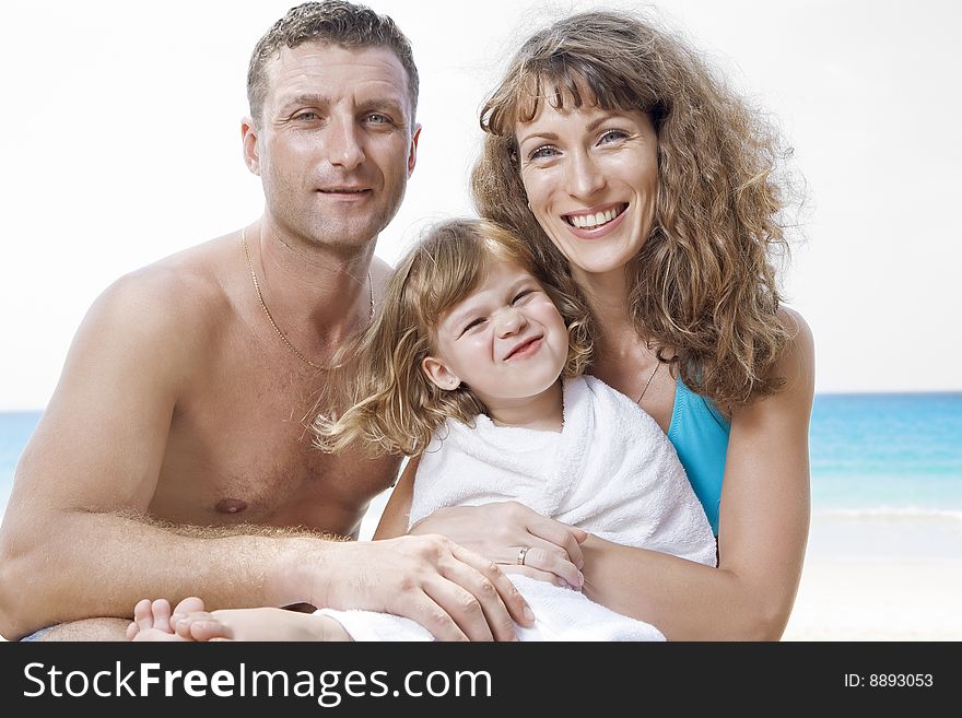 Portrait of young family having fun on the beach. Portrait of young family having fun on the beach