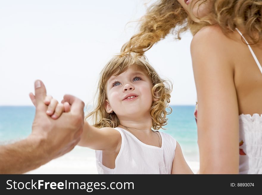 Fragment like view of young family having fun on the beach. Fragment like view of young family having fun on the beach