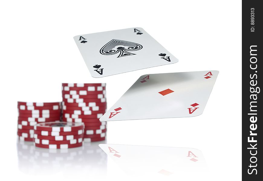 Two aces flying over a game table beside three piles of red chips. Isolated on white. Two aces flying over a game table beside three piles of red chips. Isolated on white.