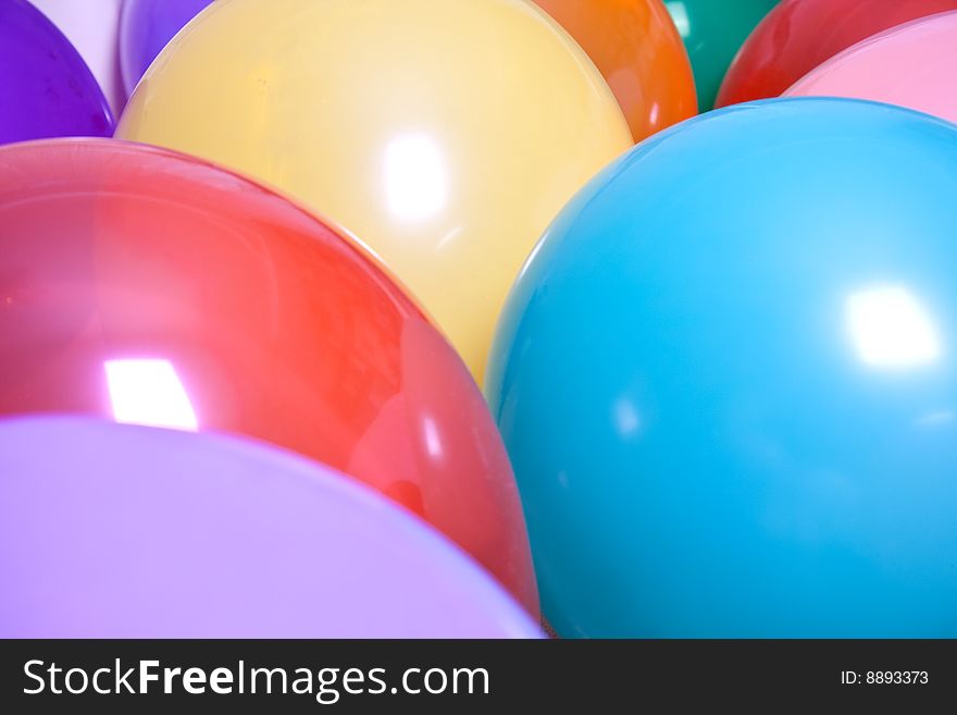 Party balloons are a group on the floor as a background