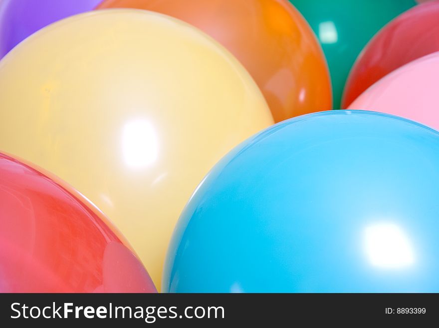 Party balloons are a group on the floor as a background