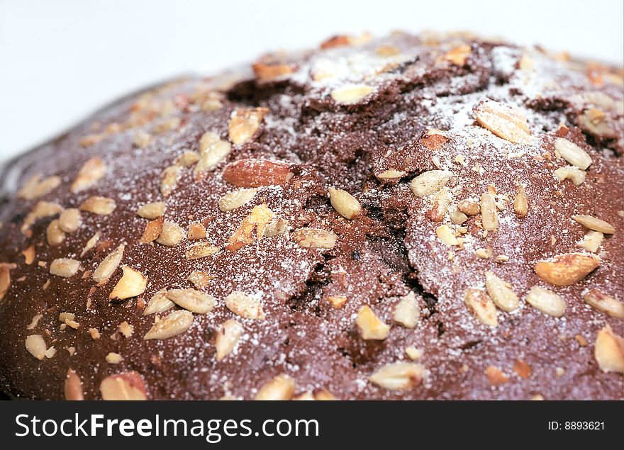 Chocolate cake with nuts and seeds close up. Chocolate cake with nuts and seeds close up