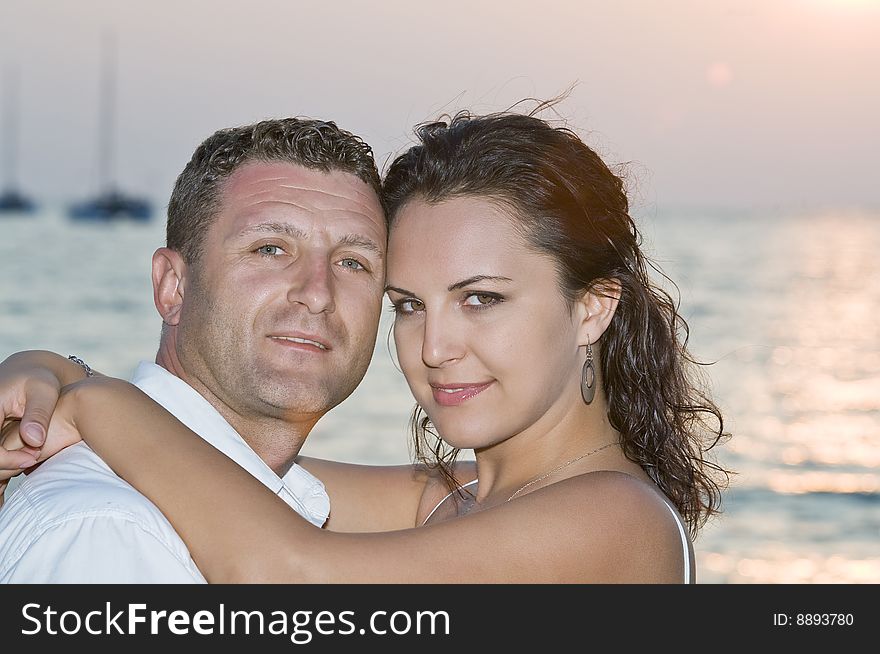 A portrait of attractive couple having fun on the beach. A portrait of attractive couple having fun on the beach.