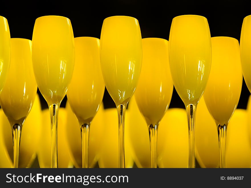 Yellow wine glasses on a plate in an restaurant