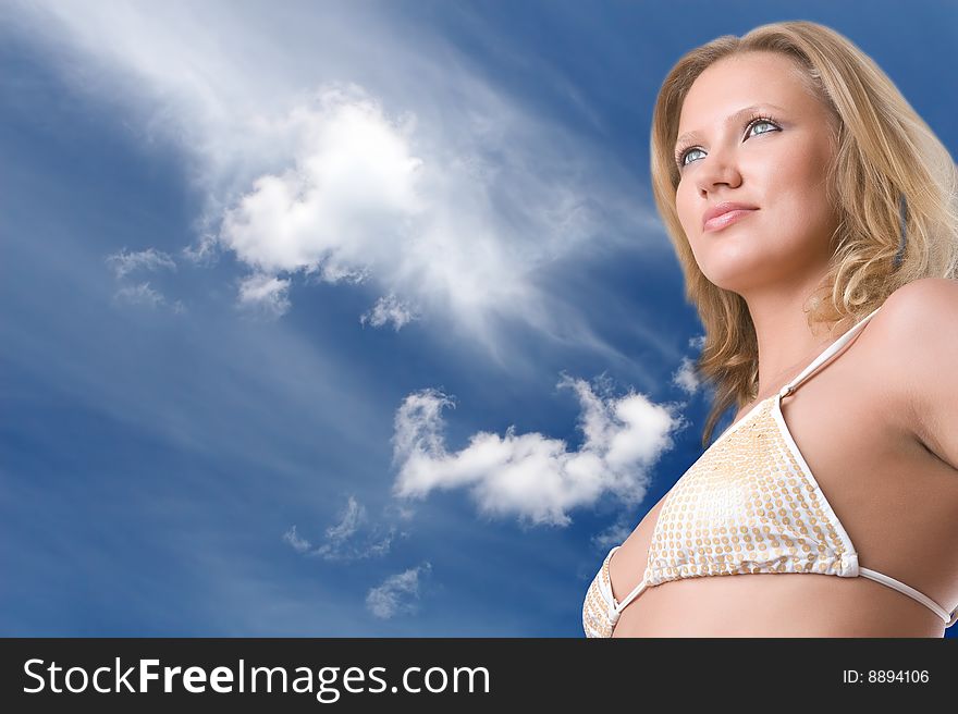 Beautiful girl in bikini against the blue sky with clouds. Beautiful girl in bikini against the blue sky with clouds