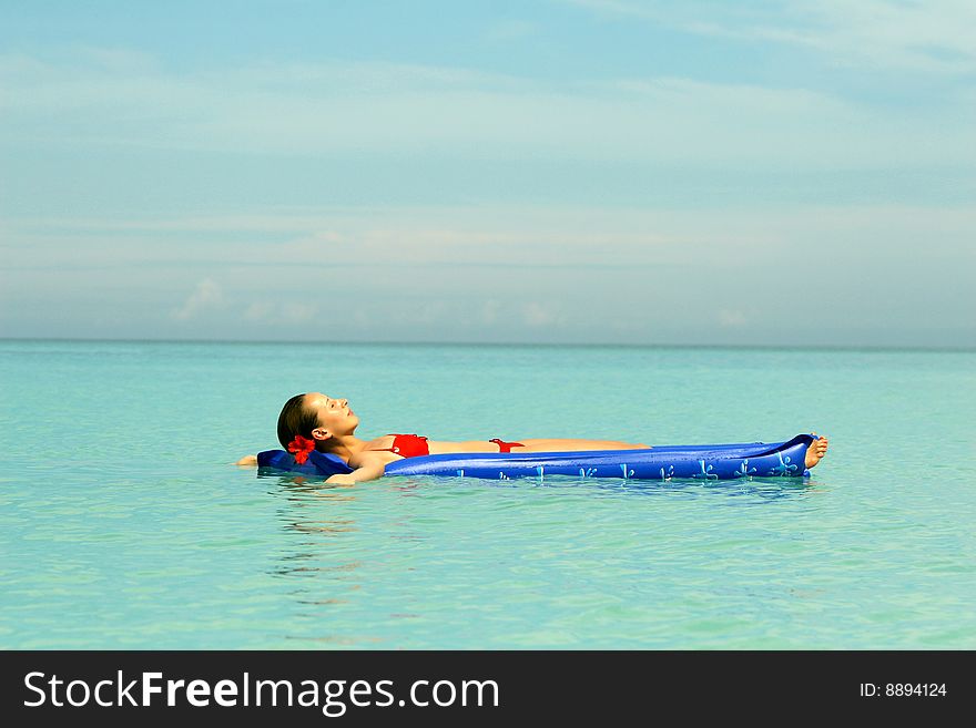 Woman Lying On An Air Mattress in ocean. Woman Lying On An Air Mattress in ocean