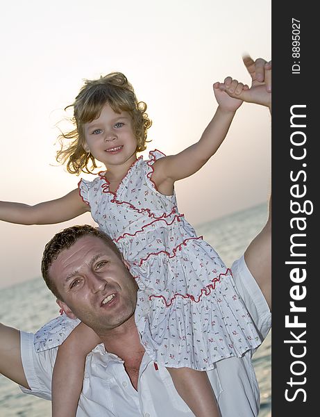 View of young family hanging out in summer environment. View of young family hanging out in summer environment.