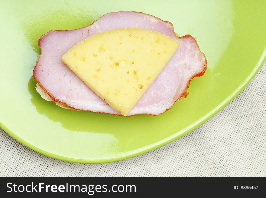 Sandwich with ham and cheese on the green plate. Sandwich with ham and cheese on the green plate.