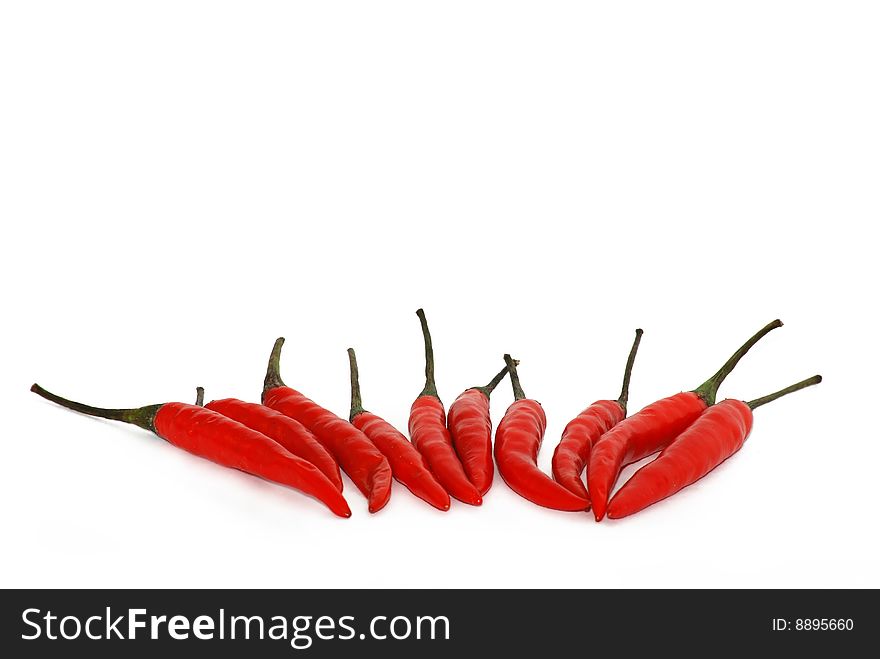 Red chili peppers isolated over white. Red chili peppers isolated over white
