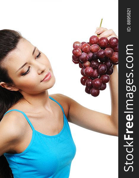 Young attractive woman holding a bunch of grapes - white background