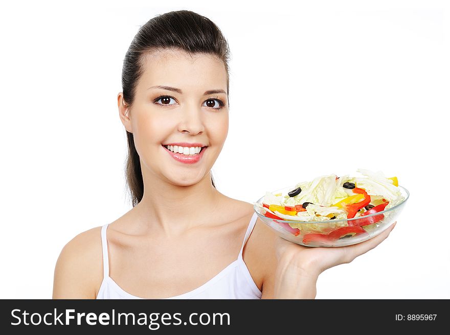 Beautiful cheerful laughing woman holding the plate with vegetables. Beautiful cheerful laughing woman holding the plate with vegetables