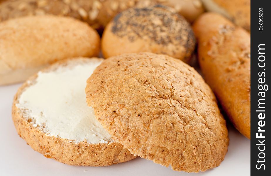 Different types of bread; half of a loaf with butter. Different types of bread; half of a loaf with butter.