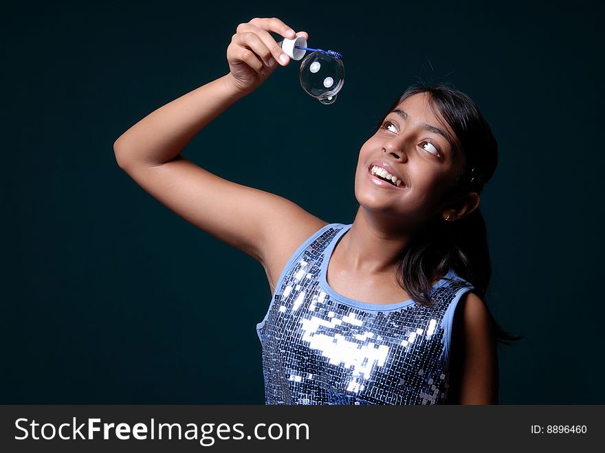 Smiling girl observing one soap bubble. Smiling girl observing one soap bubble
