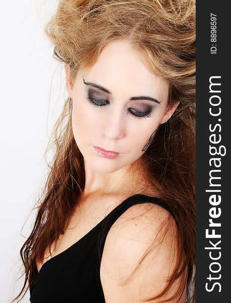 Beautiful female model with wild hair looking down