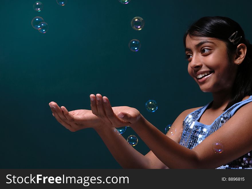 Adorable girl catches blowing soap bubbles. Adorable girl catches blowing soap bubbles