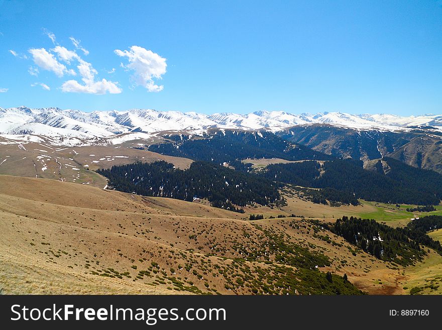 Landscape with snow mountains and clouds