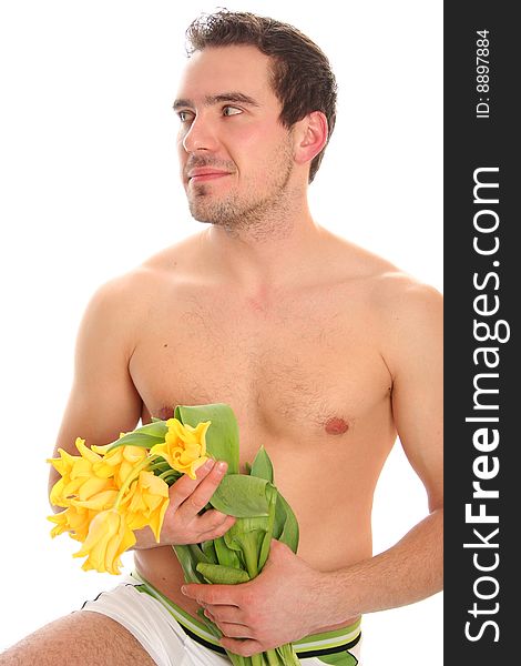 Sexy young man with yellow tulips. Sexy young man with yellow tulips