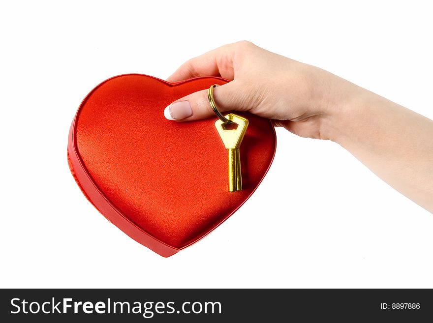Female hand holding a red box with candy and golden key. Isolated on a white background. Female hand holding a red box with candy and golden key. Isolated on a white background