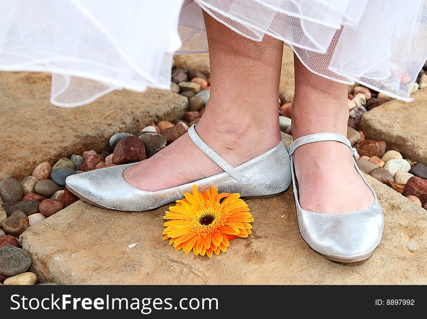 Silver Bridal shoes with a bright orange flower