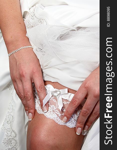 Bride showing off her garter just before the wedding ceremony. Bride showing off her garter just before the wedding ceremony