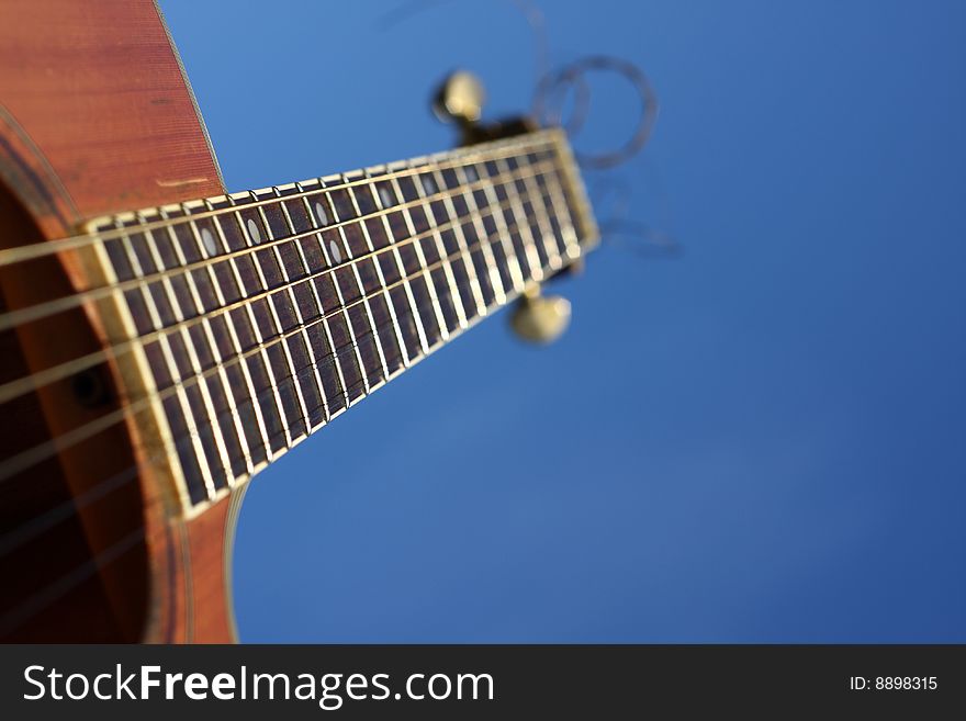 An acoustic guitar and blue sky