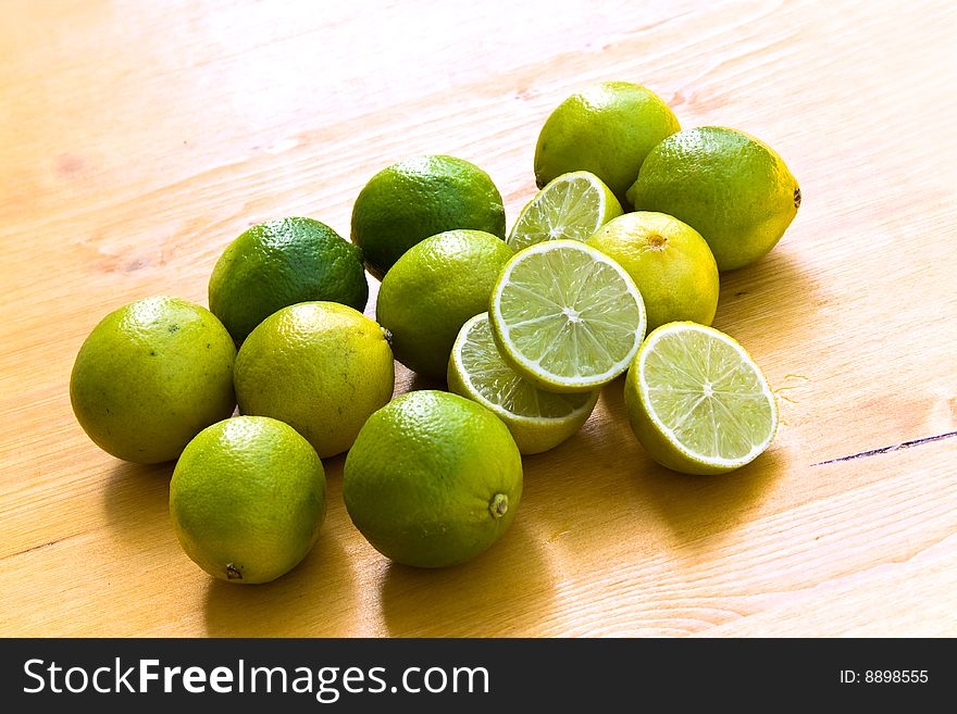 Many Ripe Limes On A Cutting Board.