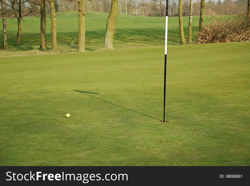 White putting flag on the green