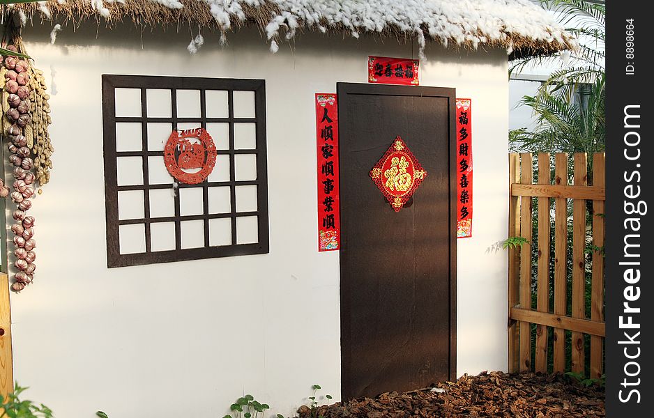 Here is typical Chinese peasant's house model,it has a traditional architectural style. Couplet and the traditional Chinese paper-cut on the window. Chinese on the couplet and the paper-cut will be to future blessing.