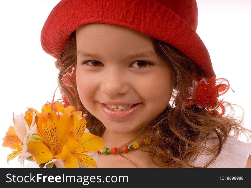 Smiling little girl in a red hat with flowers. Smiling little girl in a red hat with flowers