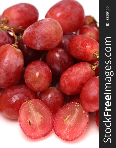 Close up of red grapes on white background.