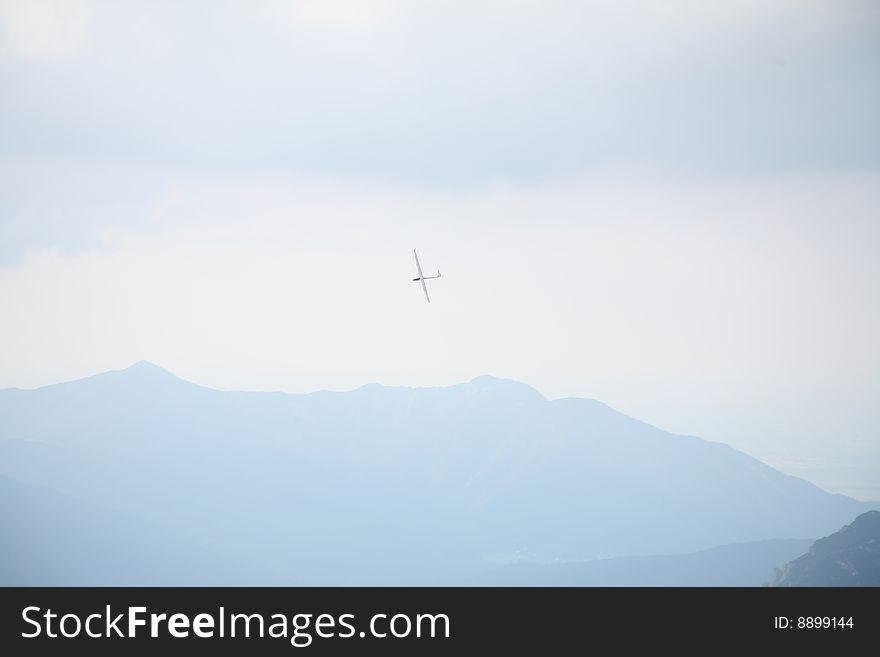 Glider plane flying over Alpine Panorama