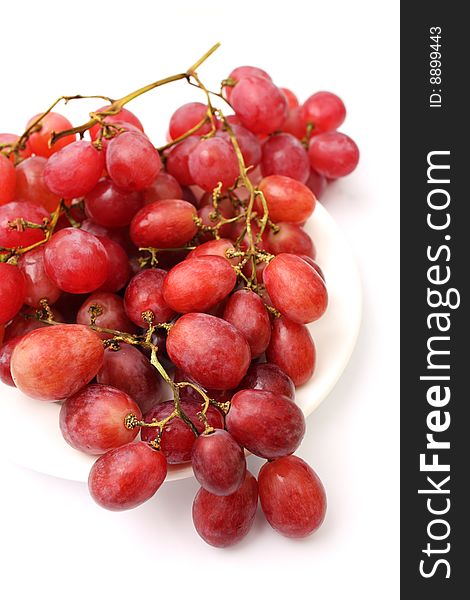 Close up of grapes on plate over white background. Close up of grapes on plate over white background.