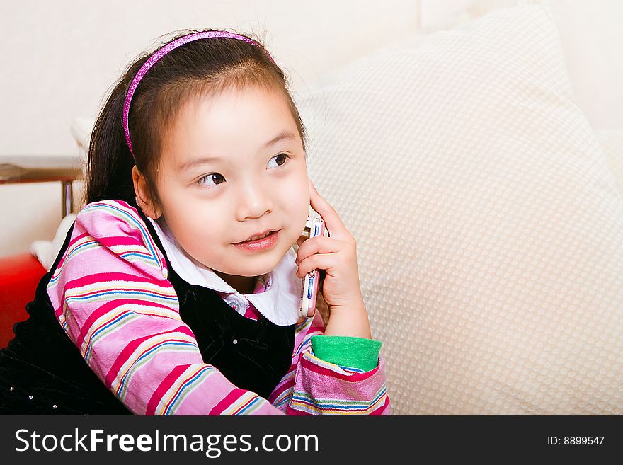 A little girl is called on the phone.