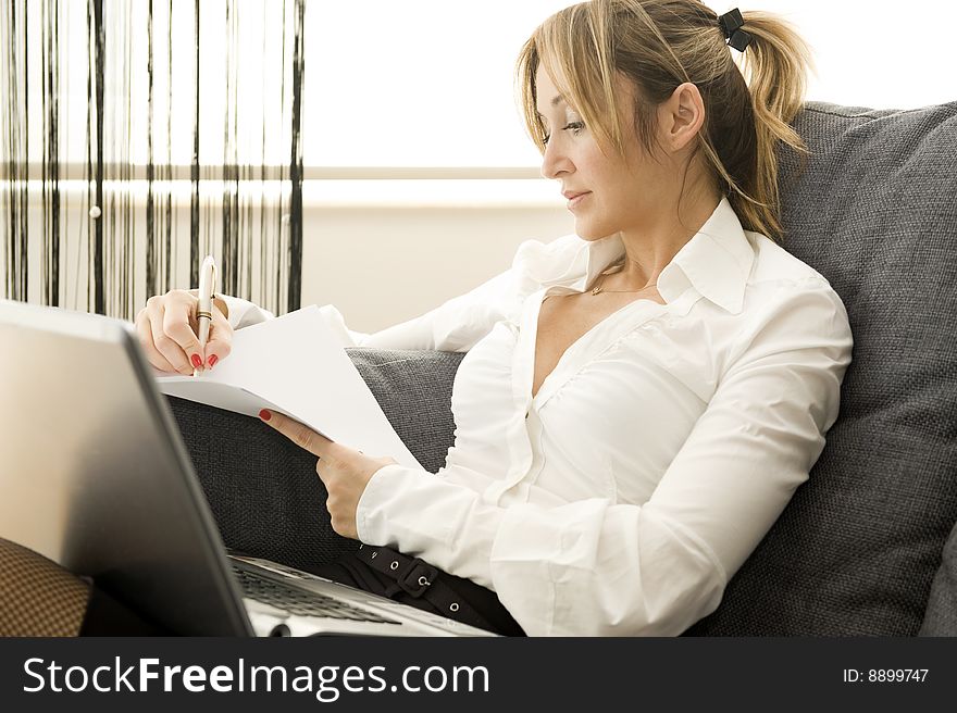 Woman working on her laptop at home. Woman working on her laptop at home