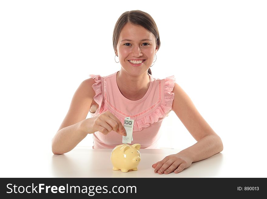 Woman putting money in piggy bank