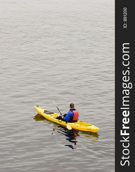 A man kayaks on the ocean. A man kayaks on the ocean