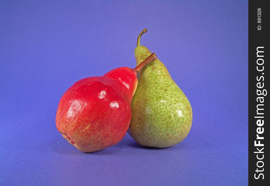 A red and a green European pears.