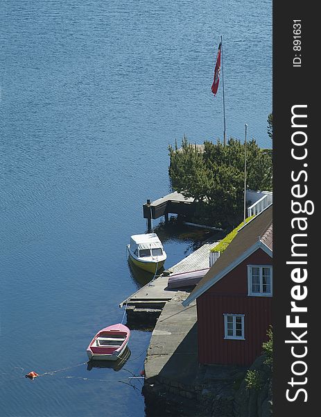 Summer house and two motorboats at the coast of southern Norway, near Farsund. Summer house and two motorboats at the coast of southern Norway, near Farsund