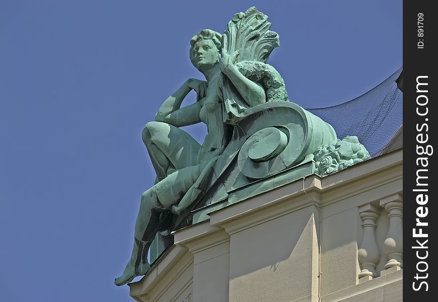 Bronze figure on top of a house in Vienna. Bronze figure on top of a house in Vienna
