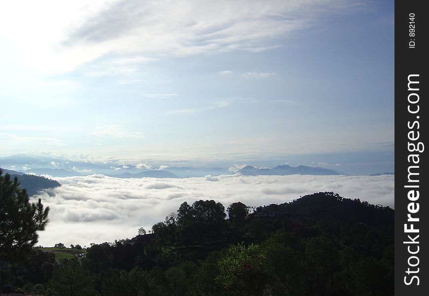 A Calm and serene view of mountain and clouds. A Calm and serene view of mountain and clouds
