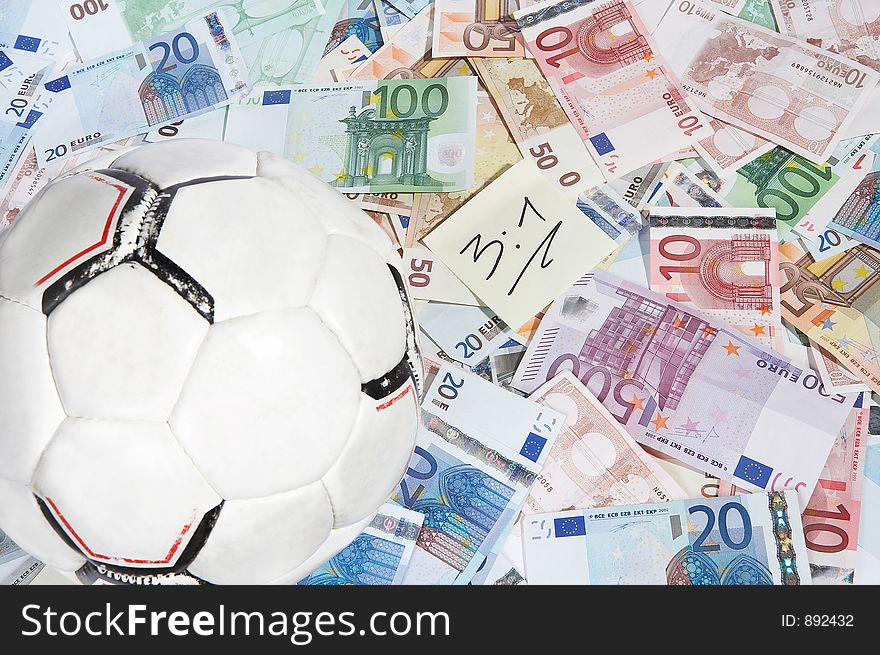 Soccerball and a shett with the right score written on it on a mixture of european papermoney. Soccerball and a shett with the right score written on it on a mixture of european papermoney