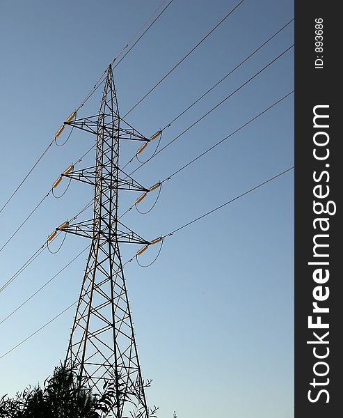 High voltage electricity Pylon against a blue sky. High voltage electricity Pylon against a blue sky