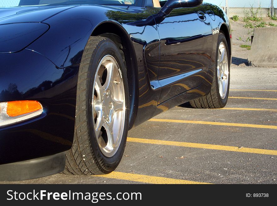 A Navy 2001 Chevy Corvette is parked on the yellow lines. A Navy 2001 Chevy Corvette is parked on the yellow lines.