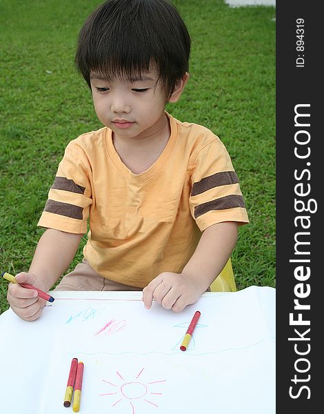 Boy Draws With Crayon