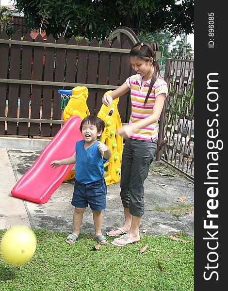 Teenage & boy playing ball