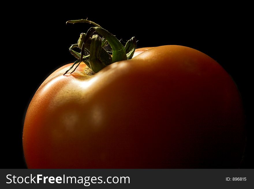 Red tomato on black background. Red tomato on black background